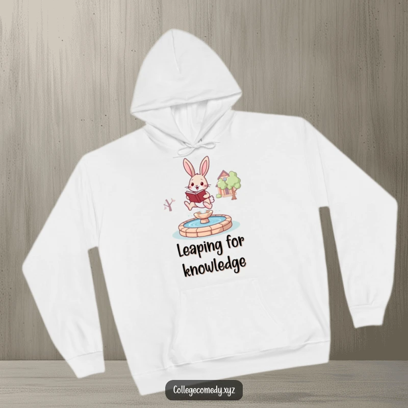 Funny bunny campus hoodie featuring a joyful bunny with a book, leaping over a stylized fountain, cozy and studious.